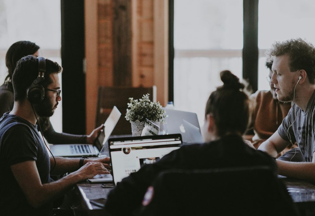 People working around a table. Photo by Annie Spratt on Unsplash