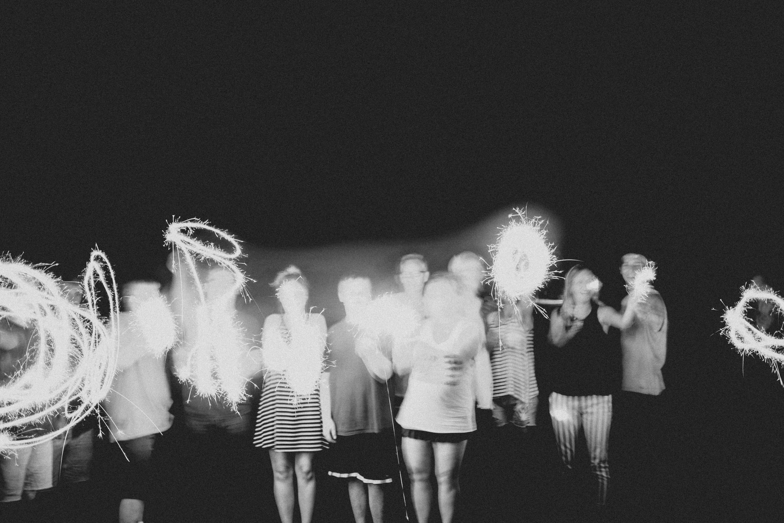 People with sparklers. Photo by Ian Harber on Unsplash