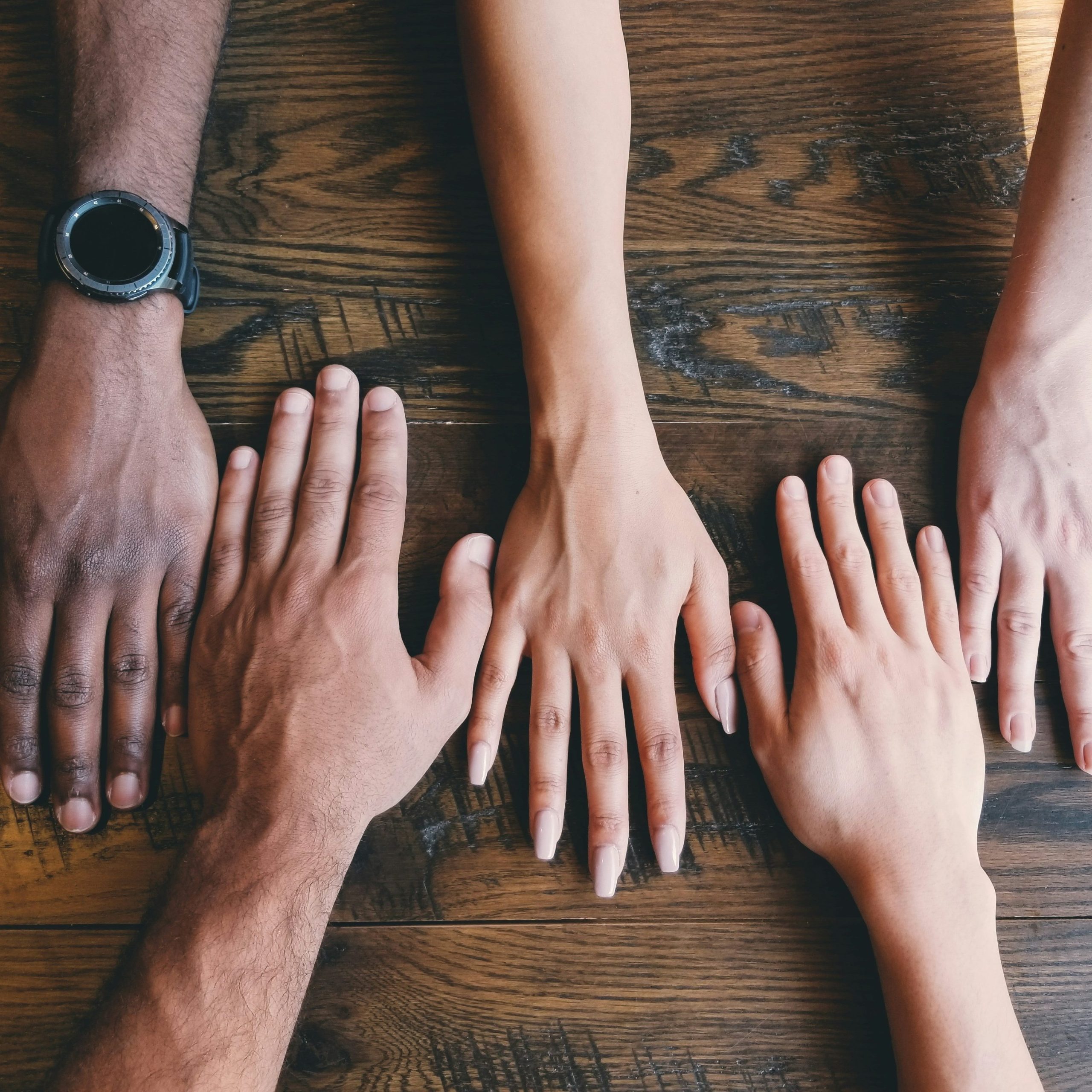 Hands on the table. Photo by Clay Banks on Unsplash